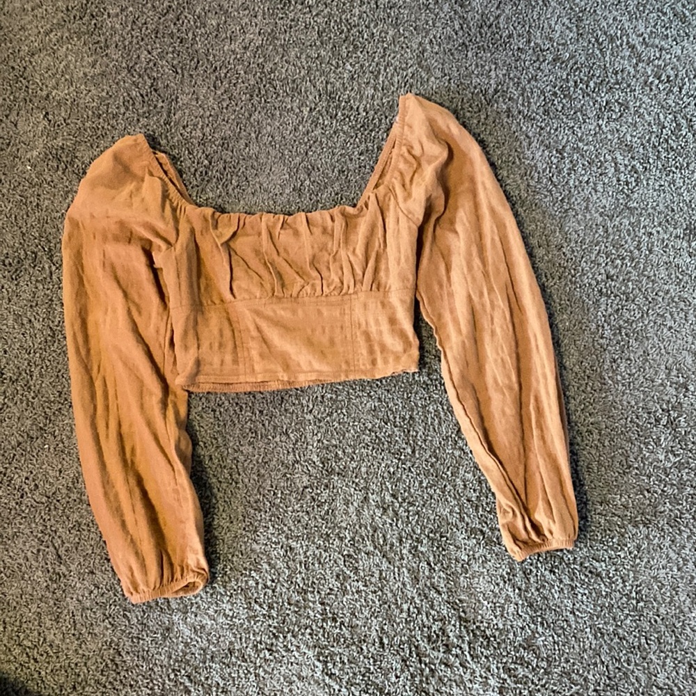 From target it’s a brown color the sleeves are a fall off type of shirt.